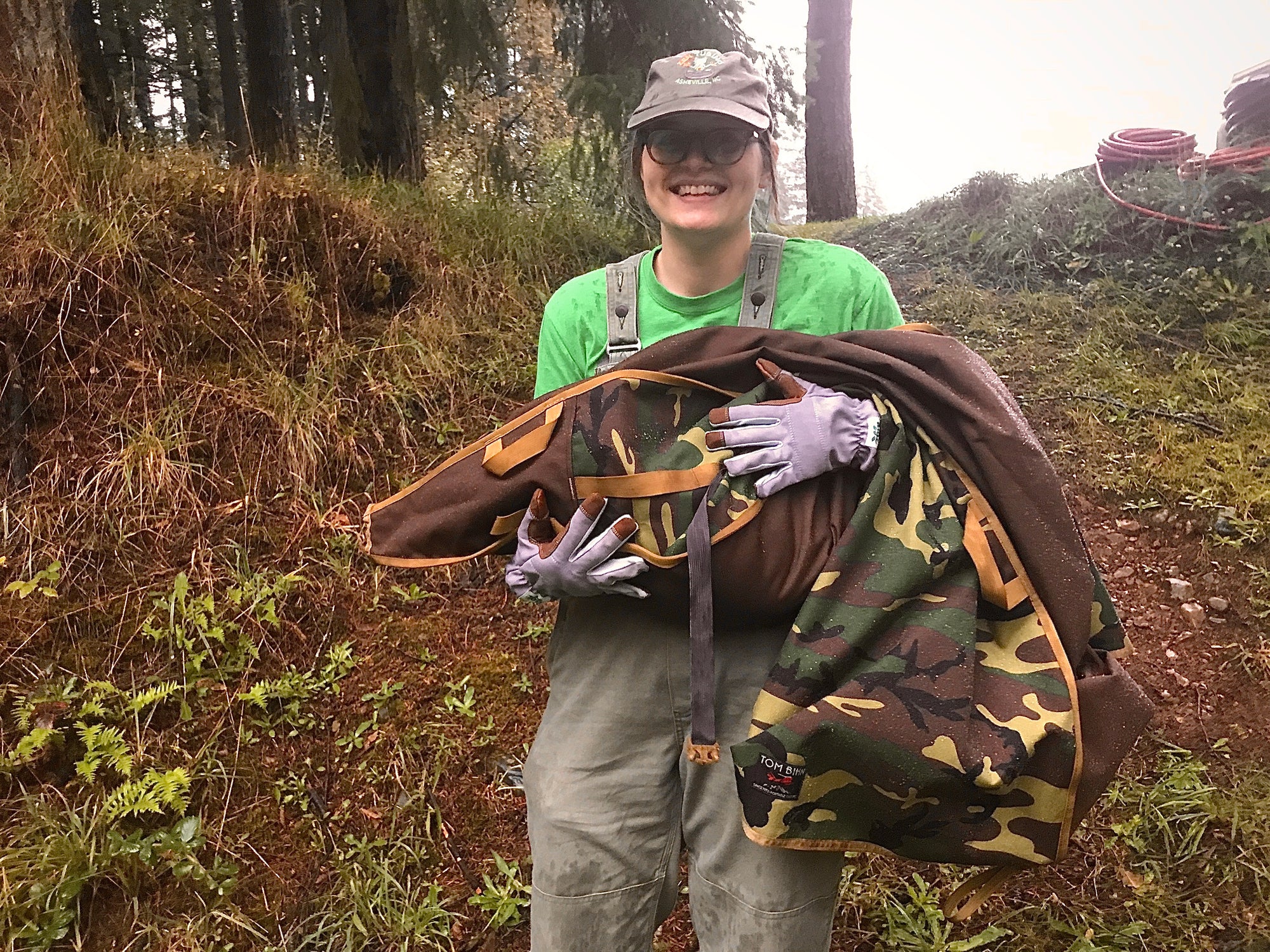 A person holding a beaver transfer bag with a mountain beaver inside.